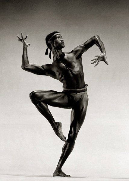 Strong and handsome dancer Mel Tomlinson holding a passé position.