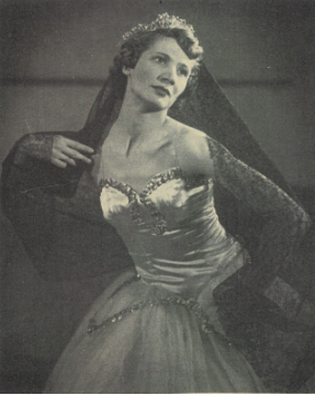 Black and white photo of Marion Cuyjet posing in a white costume with a crown and a black veil